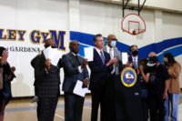 California governor Gavin Newsom stands with officials after signing police reform bills