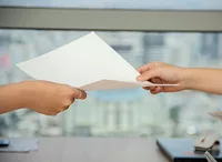 Hands holding piece of paper