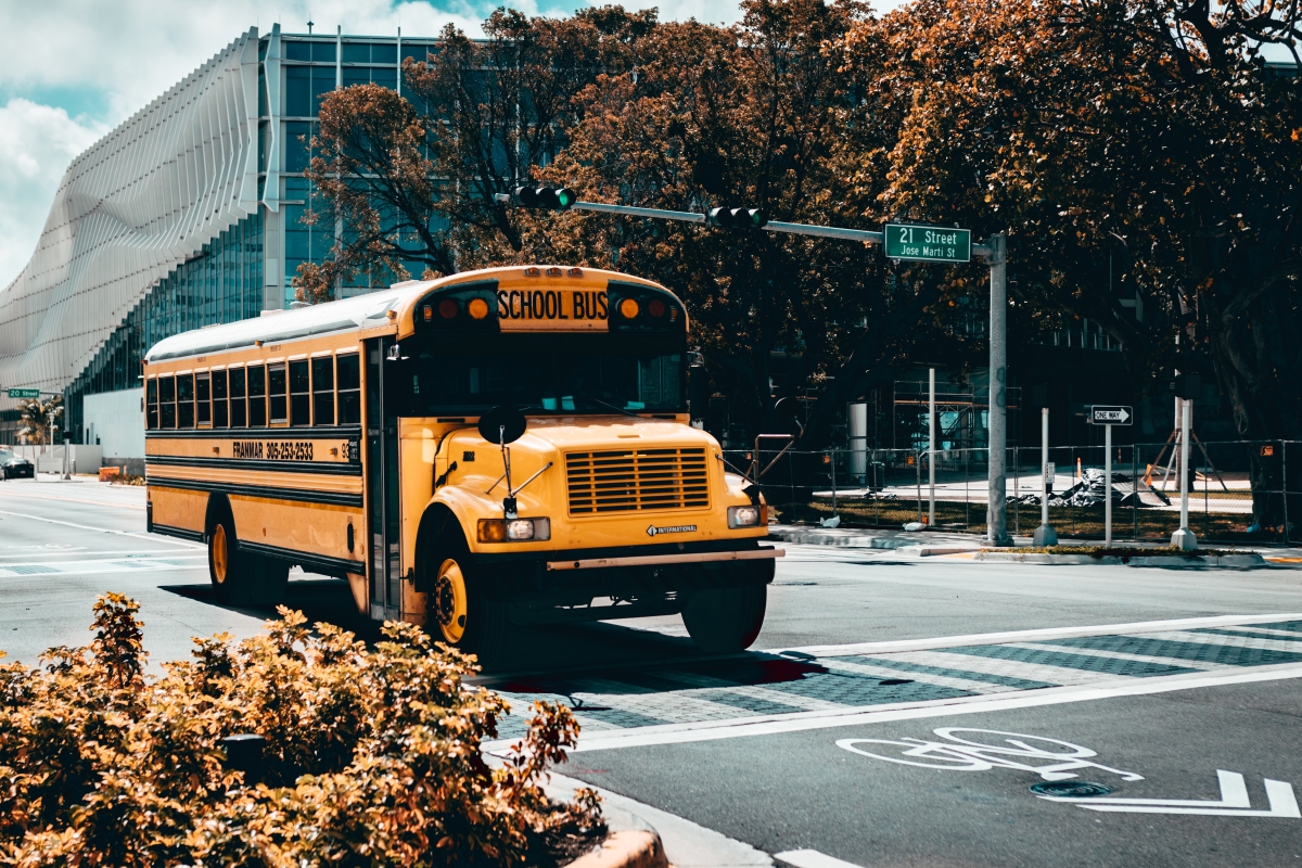 School bus drives down street