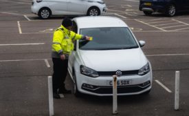 Police officer tickets a parked car