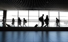 Passengers walk through airport