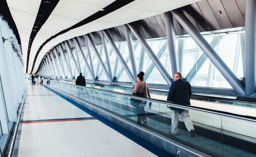 Airport travelers walk through terminal