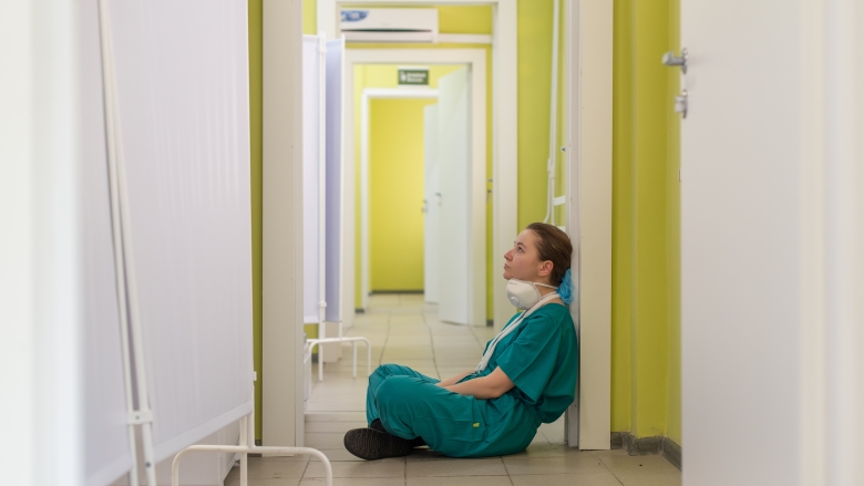 Nurse sits on floor in hospital