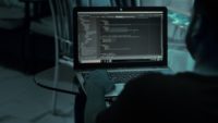 Hacker codes at computer