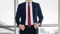 benjamin-rascoe-SRBHZzeNi6Q-unsplash.jpg Business man in suit in front of window