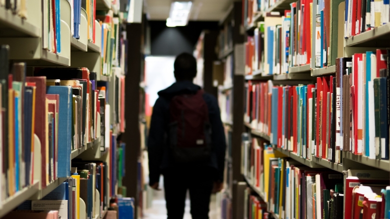 school student walks in library