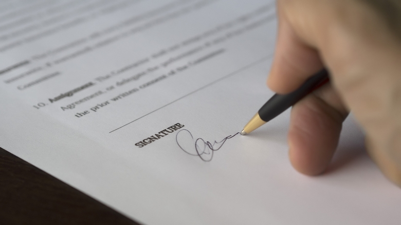person signs contract