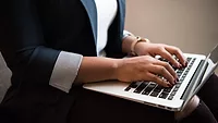 person typing on laptop