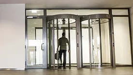 man walking through revolving door