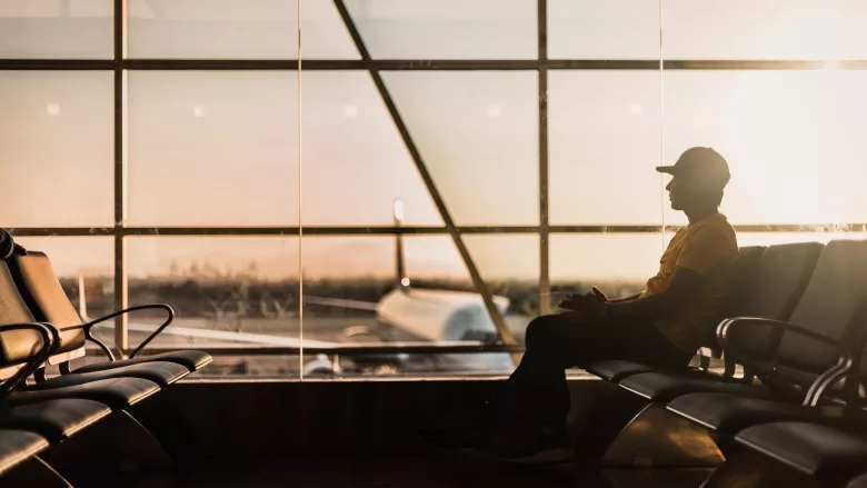 man sitting at airport gate