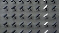 grid of security cameras with one row of white cameras