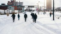 people walking on snow-covered street