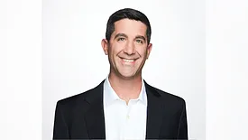 Keith Anderson headshot. He's smiling and wearing a suit