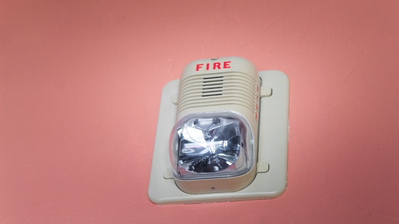 fire alarm on pink wall