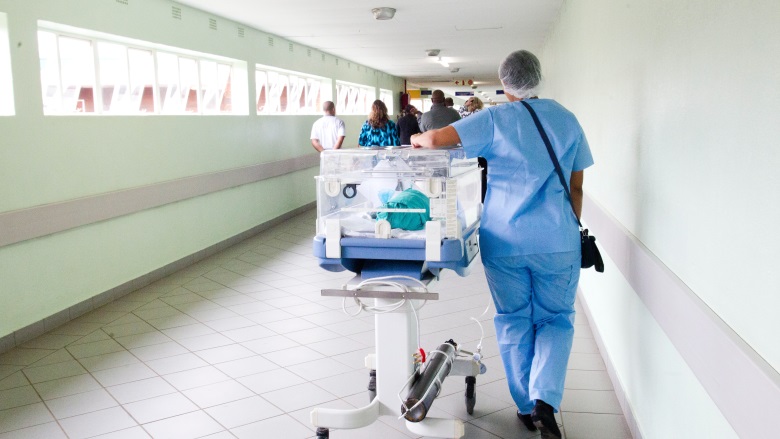 healthcare worker walking down hallway
