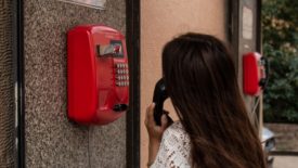 person using red emergency phone