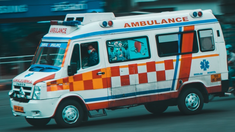 ambulance driving down street