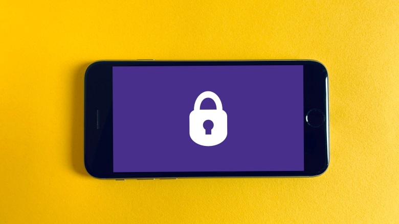 phone with lock on purple screen and yellow background