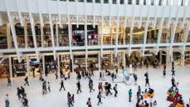 people moving through shopping center