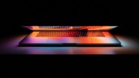 half open laptop with pink and orange lighting