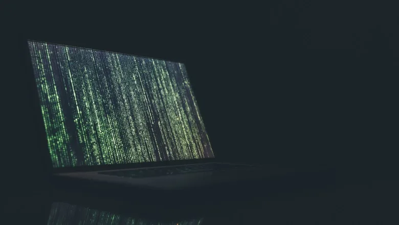 open computer with green vertical text