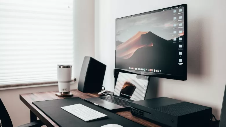 computer desk with keyboard and speaker