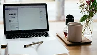 desk with laptop, notebook and coffee cup desk with laptop, notebook and coffee cup