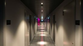 dimly lit hallway with closed doors