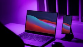 Computer next to phone with purple lighting