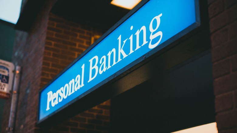 blue street sign that says personal banking