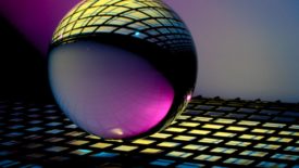 sphere on black grate with purple and yellow lighting