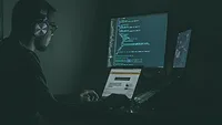 person working at a computer with headphones person working at a computer with headphones