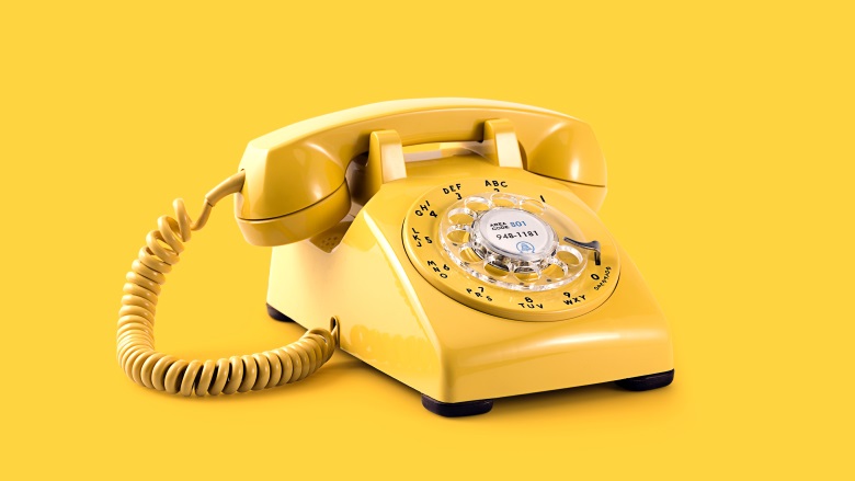 yellow corded phone on yellow background