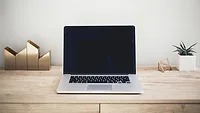laptop on wooden desk laptop on wooden desk