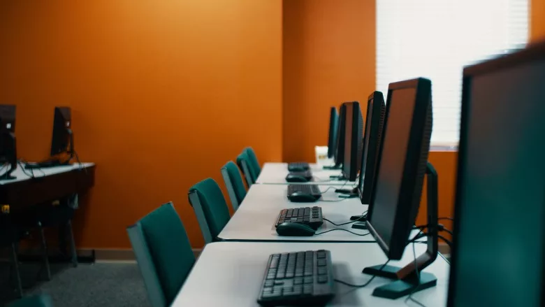row of desktops on table