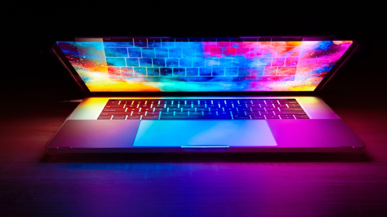 half open laptop with pink and blue lights