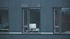 person working on computer near a window