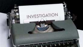 Typewriter with investigation written on a piece of paper
