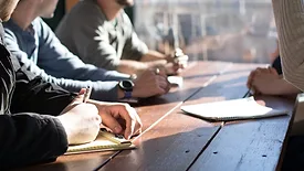 people working at wooden table