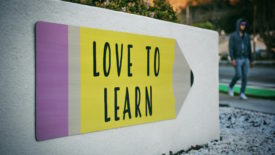 School sign with pencil that says love to learn