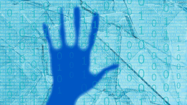 Blue hand in front of binary code