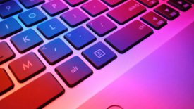 Laptop keyboard with pink and orange light
