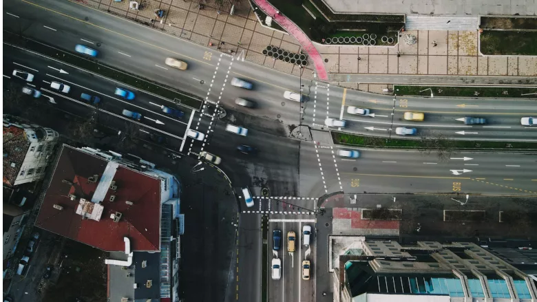 Busy city intersection with many fast moving cars