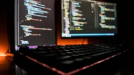 Two monitors and keyboard on desk