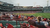 Baseball fans sitting in stadium and watching game