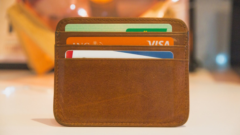 Small leather wallet holding credit cards