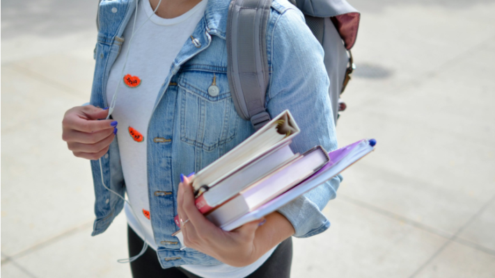 Girl with backpack and textbooks