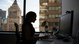 Silhouette of woman at computer