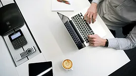 Person working at desk with coffee