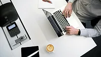 Person working at desk with coffee Person working at desk with coffee